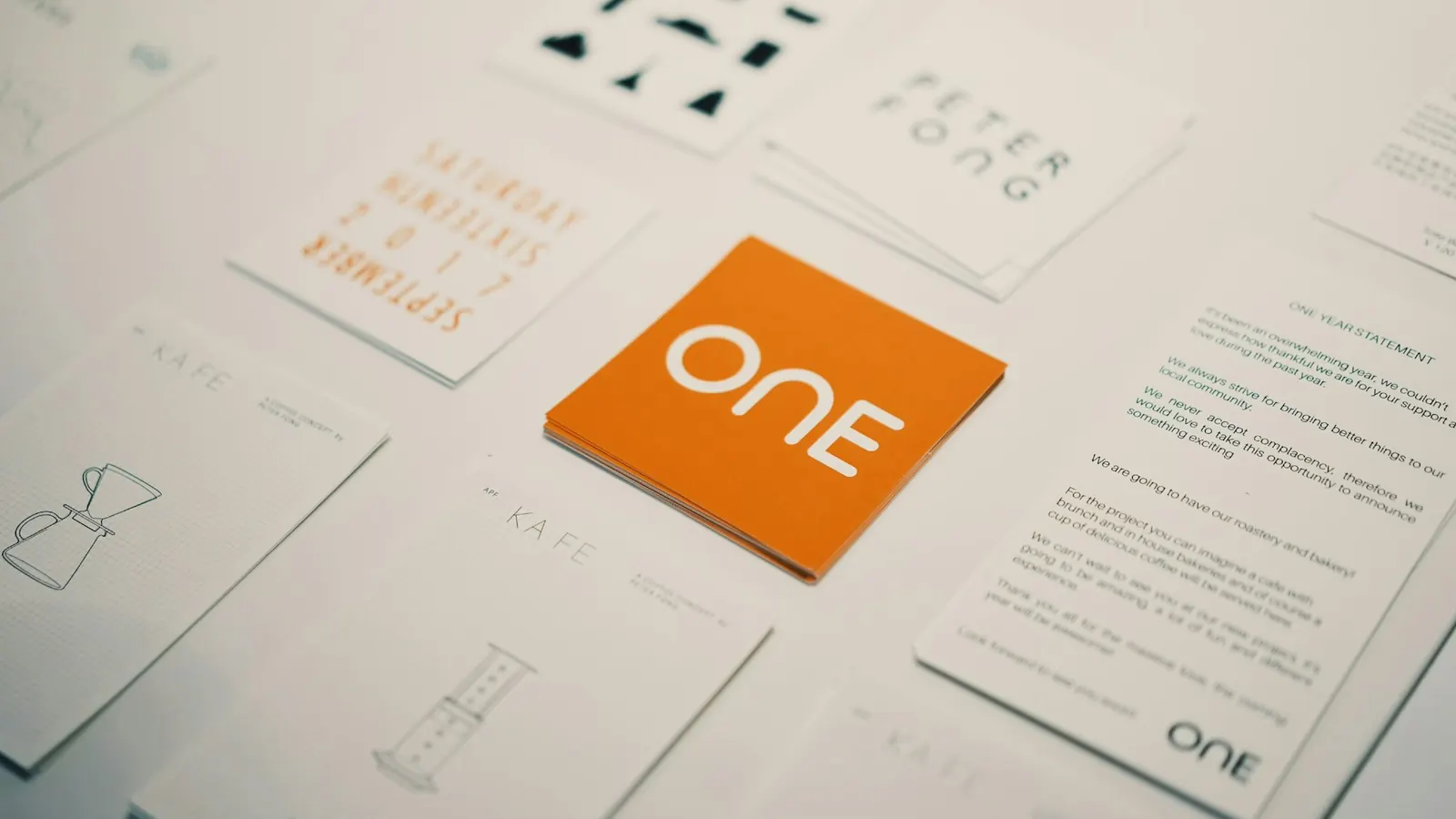 Brand identity cards and stationery laid out on a table